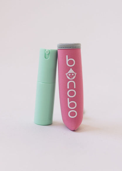 Variant shot showing the pouch and bottle in pink and grey configuration with elastic band and bottle nozzle visible for color selection clarity.