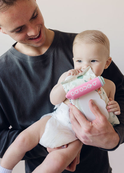 Pouch and spritzer displayed together on a neutral background, showing overall silhouette, fabric texture, and elastic band placement for wipes.