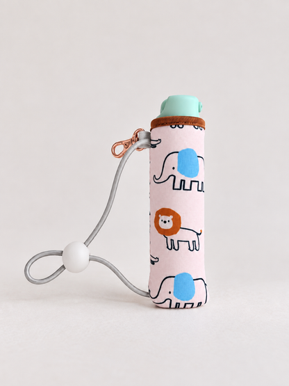 Bonobo baby bidet in Safari print with the elastic cord and cord lock that secure it to a wipes pack