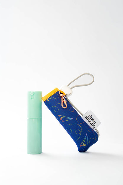 Small blue pouch with a white tag and mint green item on a white background