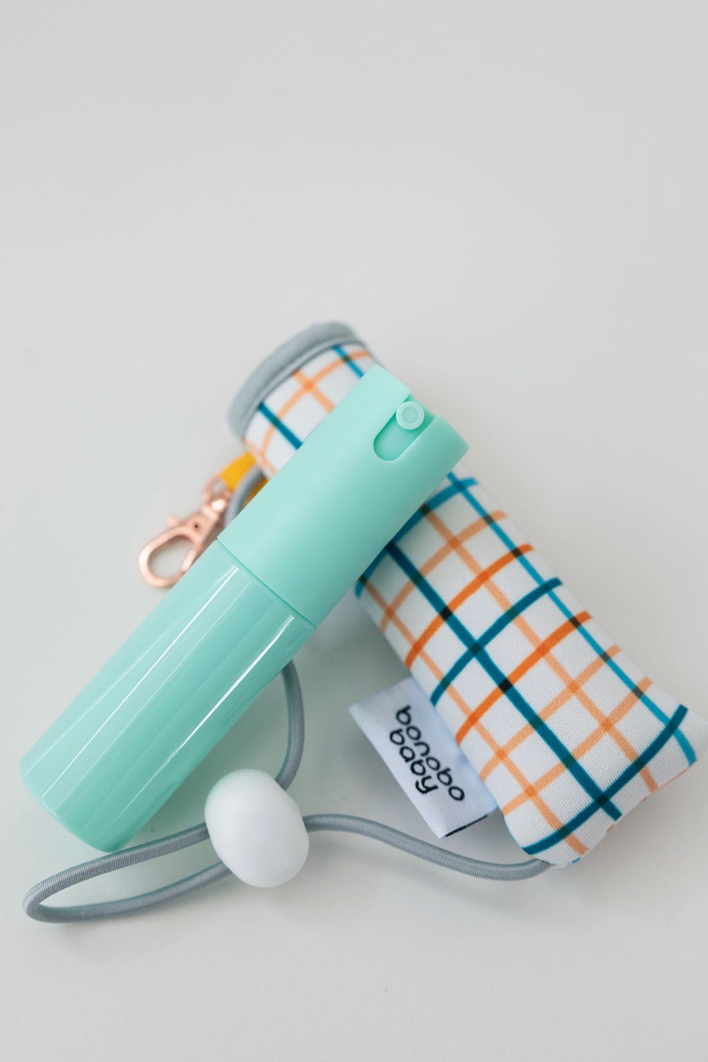 harvest gingham baby bidet pouch with the mint green 20 ml spritzer on a white background 