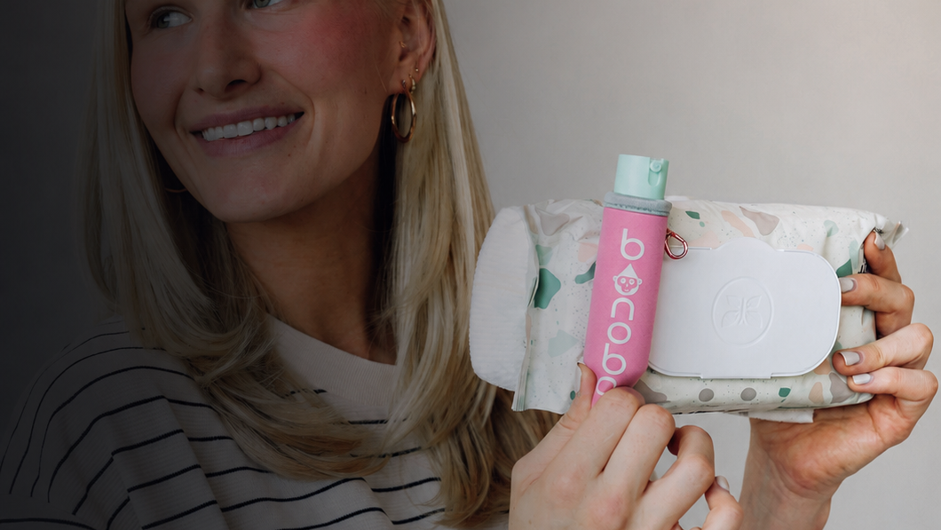 woman holding wipes pack with pink bonobo baby bidet 
