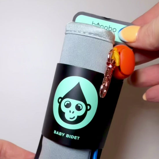 a video demonstration showing how to use the Bonobo Baby Bidet by securing it to a baby wipes pack or clipping it to a diaper bag.