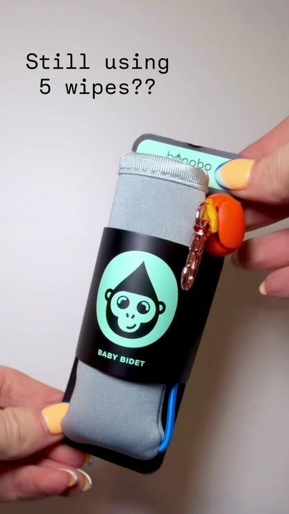 a video demonstration showing how to use the Bonobo Baby Bidet by securing it to a baby wipes pack or clipping it to a diaper bag.